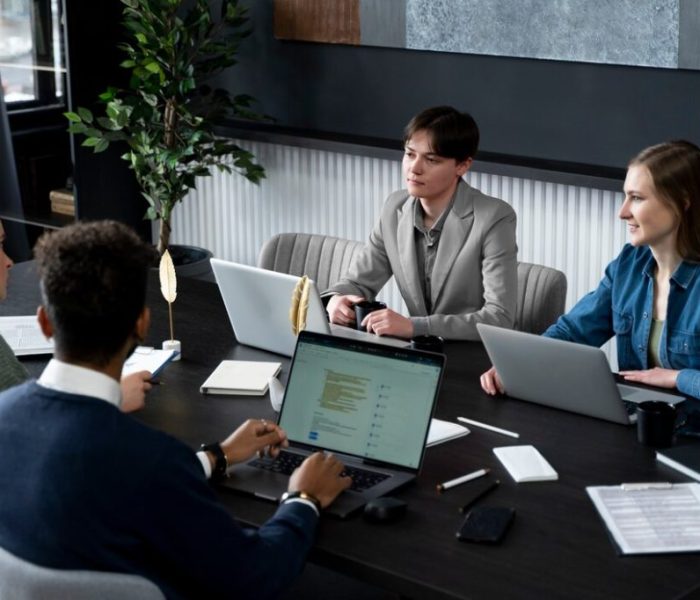trans-person-working-office-with-colleagues_23-2149286965 trans-person-working-office-with-colleagues_23-2149286965